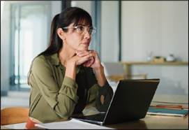 A person sitting at a desk with a computer

AI-generated content may be incorrect.